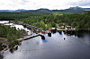 Damm og kraftstasjon ved Tjønnefossen i eit skogkledd vassdrag.